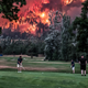 The Eagle Creek wildfire burns as golfers play in Washington state in 2017.